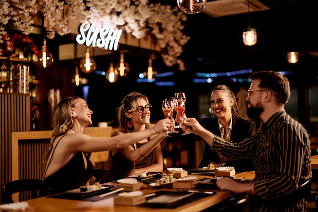 Friends laughing together over dinner